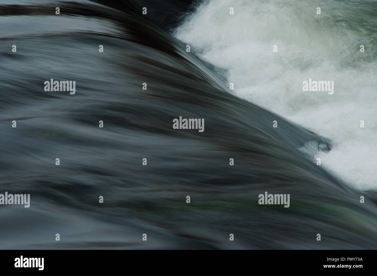 Dark water wave on the river with lot of foam. Stock Photo