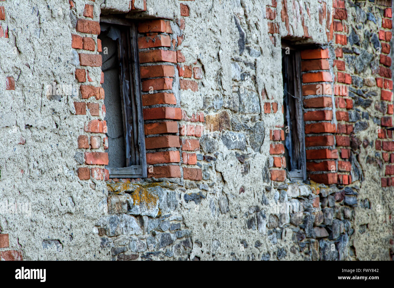 Two windows in the old stone brick wall. Stock Photo