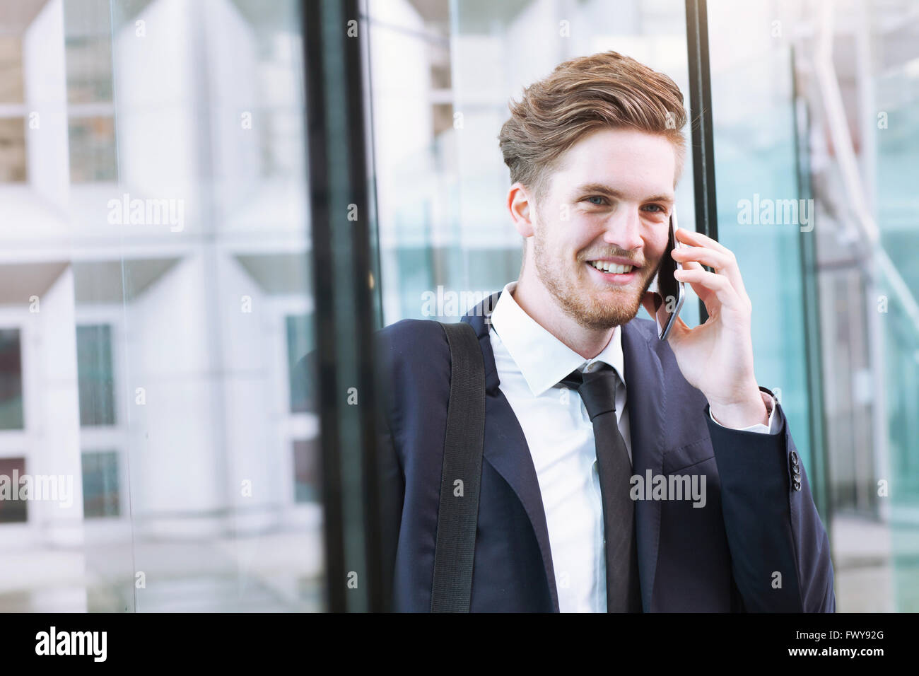 portrait of smiling businessman talking by phone Stock Photo