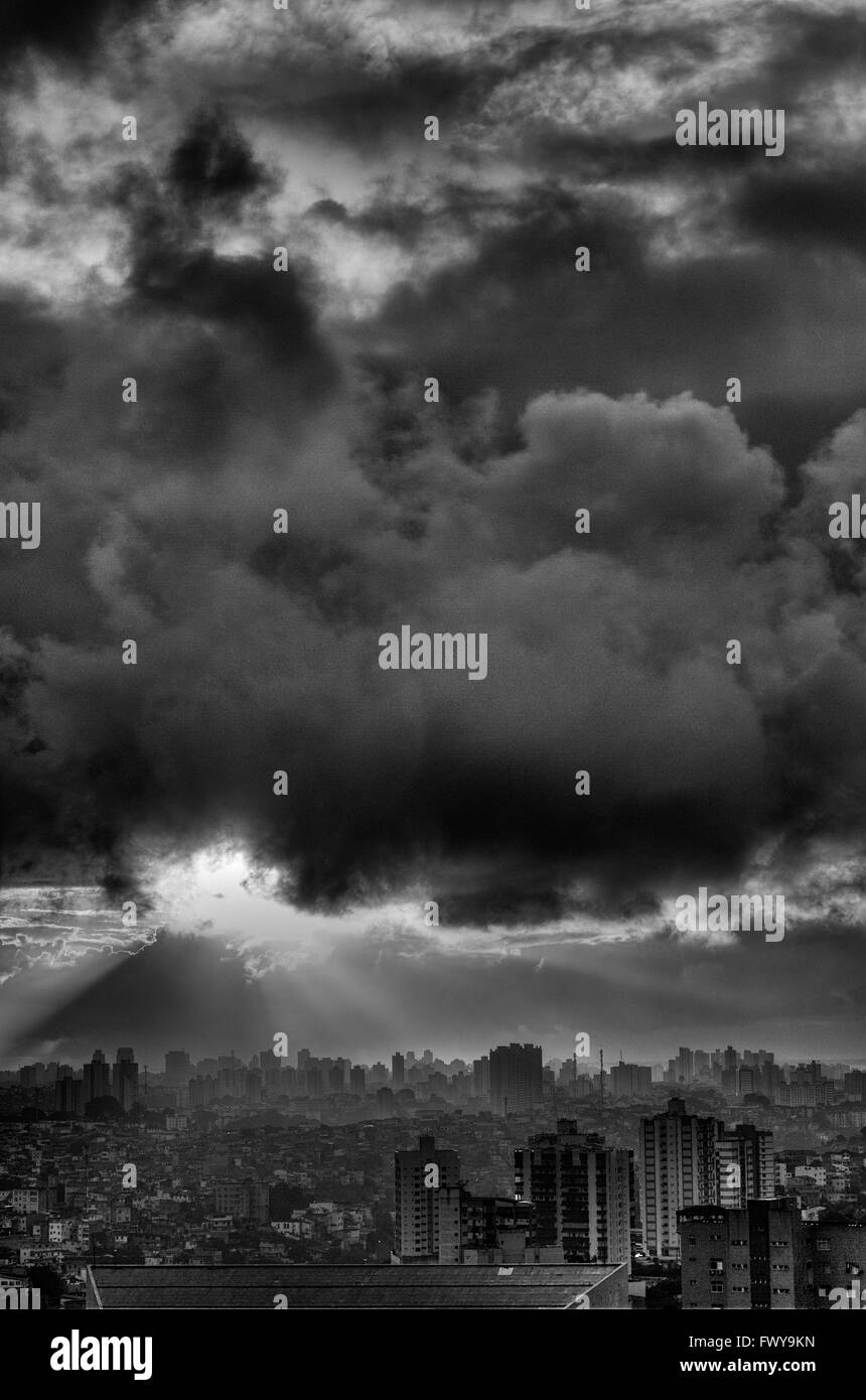 Black and white urban landscape of Salvador with dramatic low clouds and sun rays, Bahia, Brazil Stock Photo