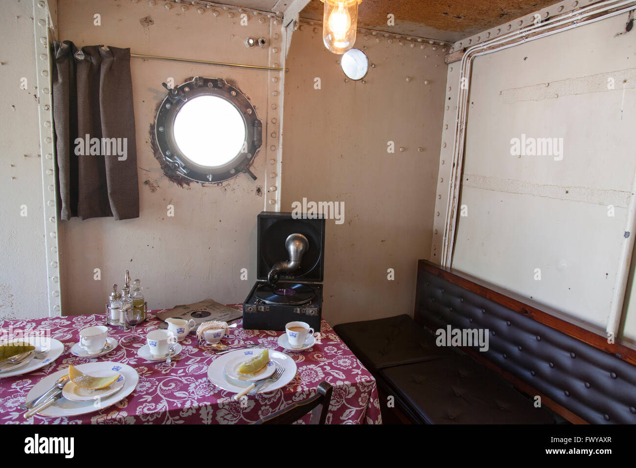 The Wardroom at meal time on board HMS M33 in the Royal Naval Dockyard, Portsmouth. Stock Photo
