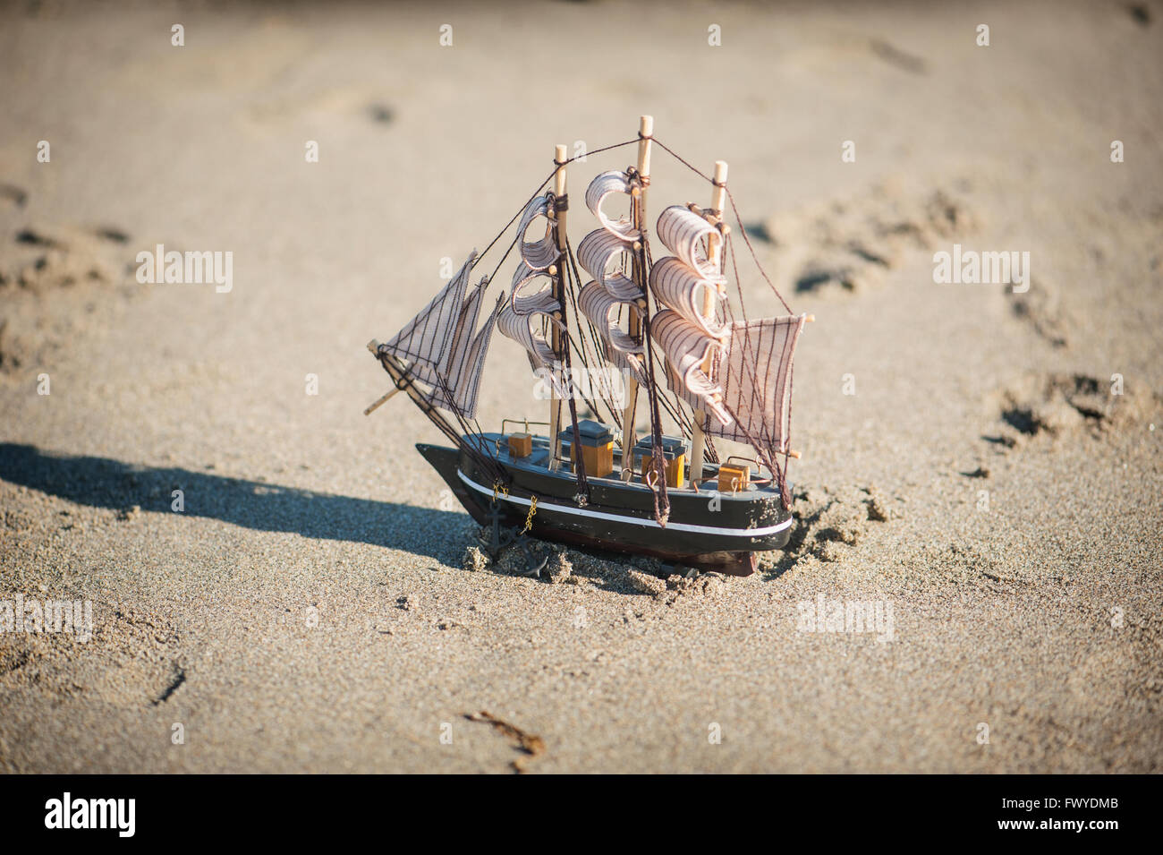 ship is a toy in the sand Stock Photo