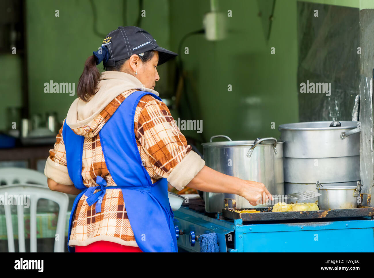 Banos De Agua Santa,  - 29 November 2014: Latin Woman Cooking On The Streets Of Banos De Agua Santa, Ecuador In Banos Stock Photo