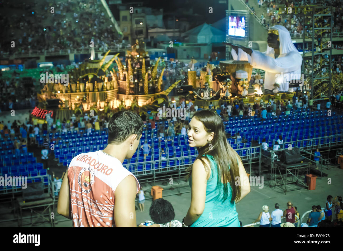 young people enjoying at the Sambodromo for Rio Carnival 2016 with alegorical wagon as background Stock Photo