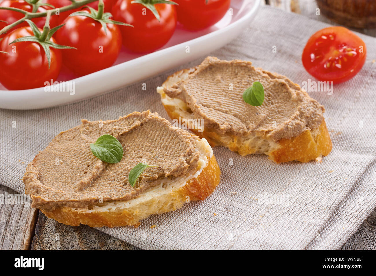 Bread with chicken liver pate and tomatoes Stock Photo