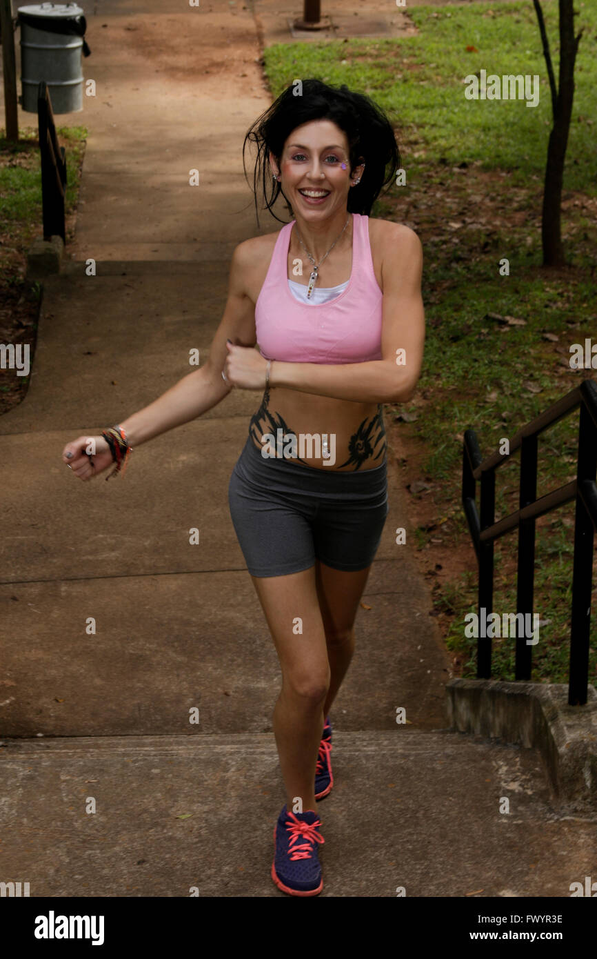 Young woman running up stairs Stock Photo Alamy