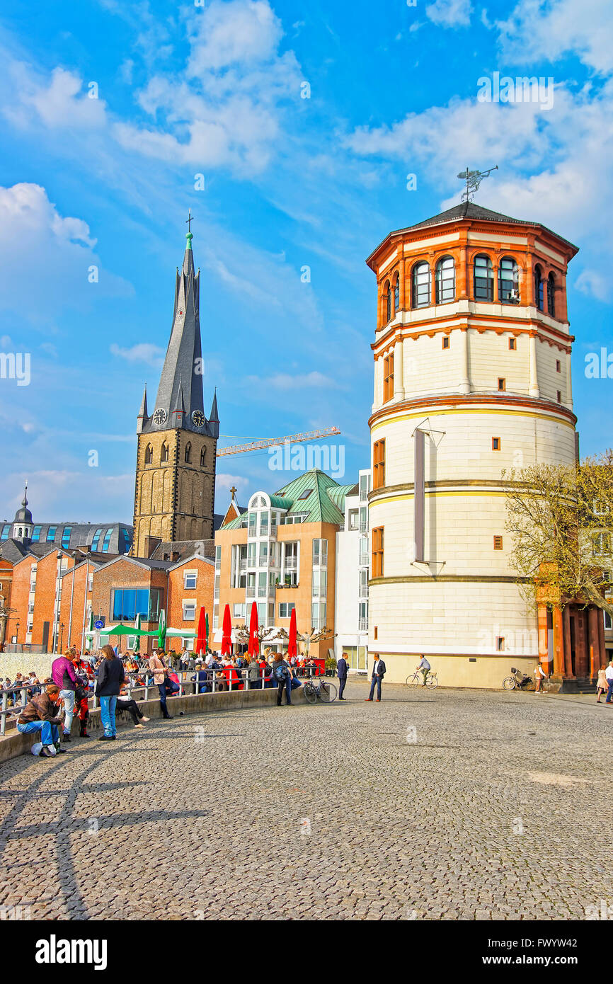 DUSSELDORF, GERMANY - MAY 3, 2013: St Lambertus Church and Schiffahrtmuseum in city center of Dusseldorf. Tourists nearby Stock Photo