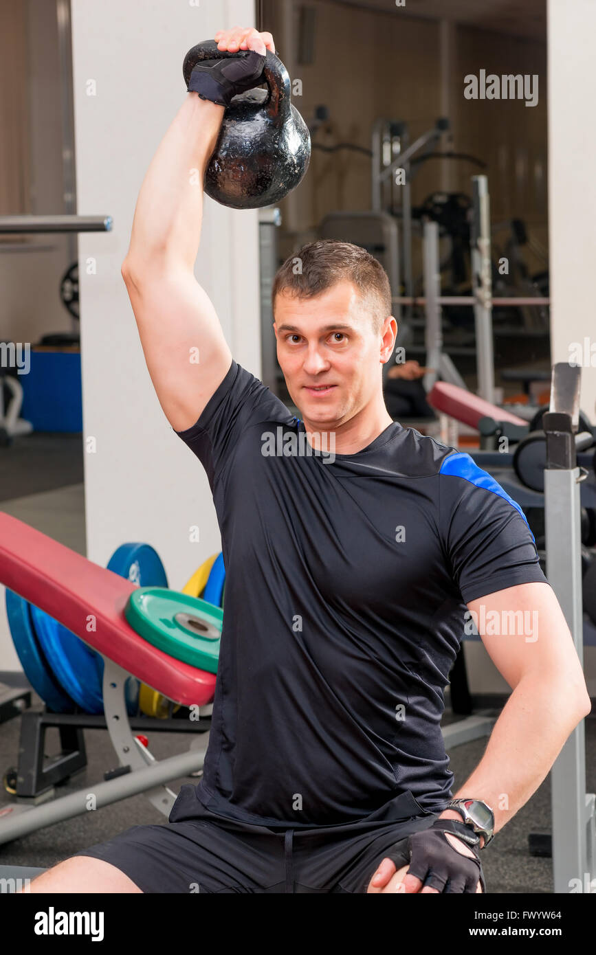 athlete with heavy weights above his head at arm's length Stock Photo