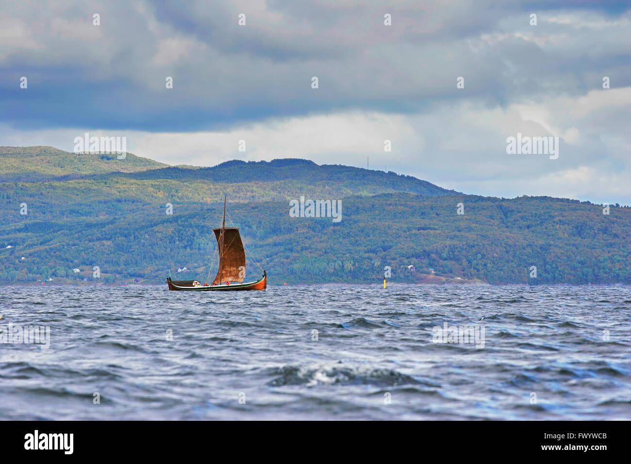 A traditional wooden Nordland boat is sailing on Ofotfjorden in
