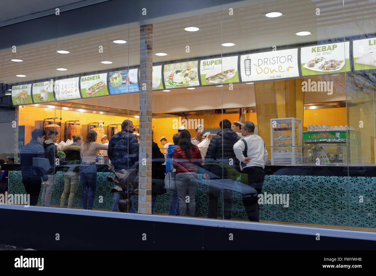 People in the Middle Eastern fast food restaurant Dristor Kebab in Bucharest, Romania Stock Photo