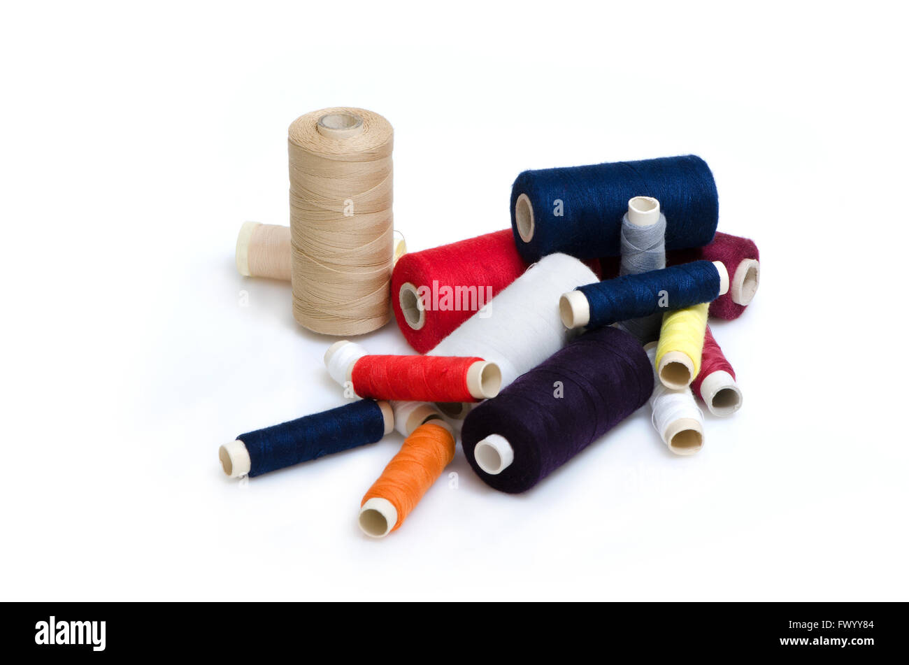 Heap of plenty colorful thread reels isolated on white background. Stock Photo