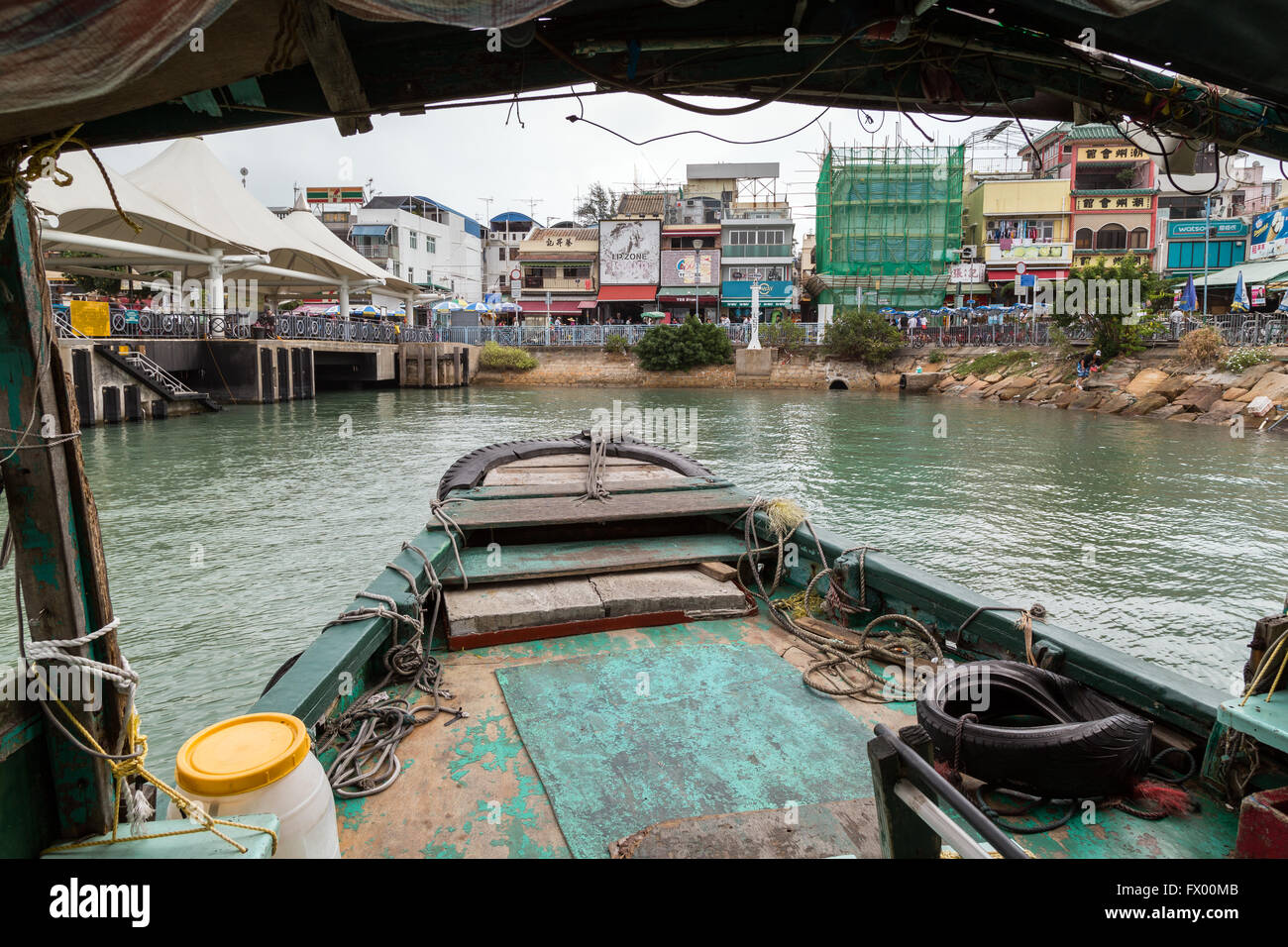 Sampan ferry arriving the pier at the Cheung Chau Island in Hong Kong, China. Viewed from the ferry. Stock Photo