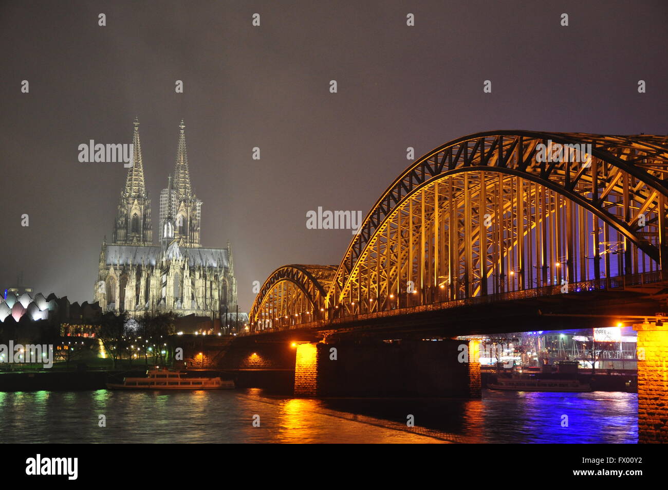 Cologne Cathedral and Hohenzollern bridge at night with light Stock Photo