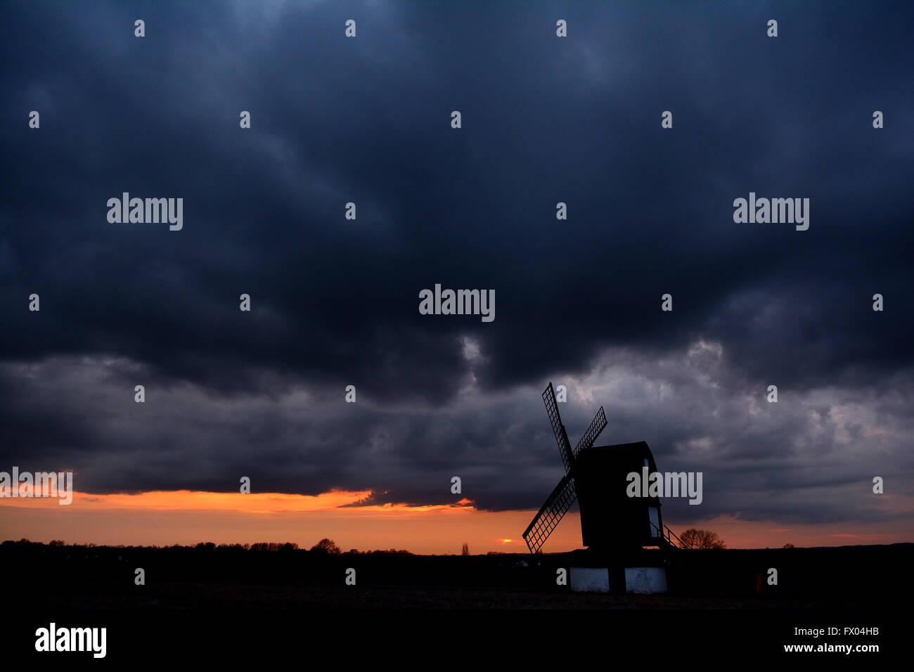 Dramatic thunder clouds at sunset over Pitstone Windmill, Buckinghamshire, UK Stock Photo
