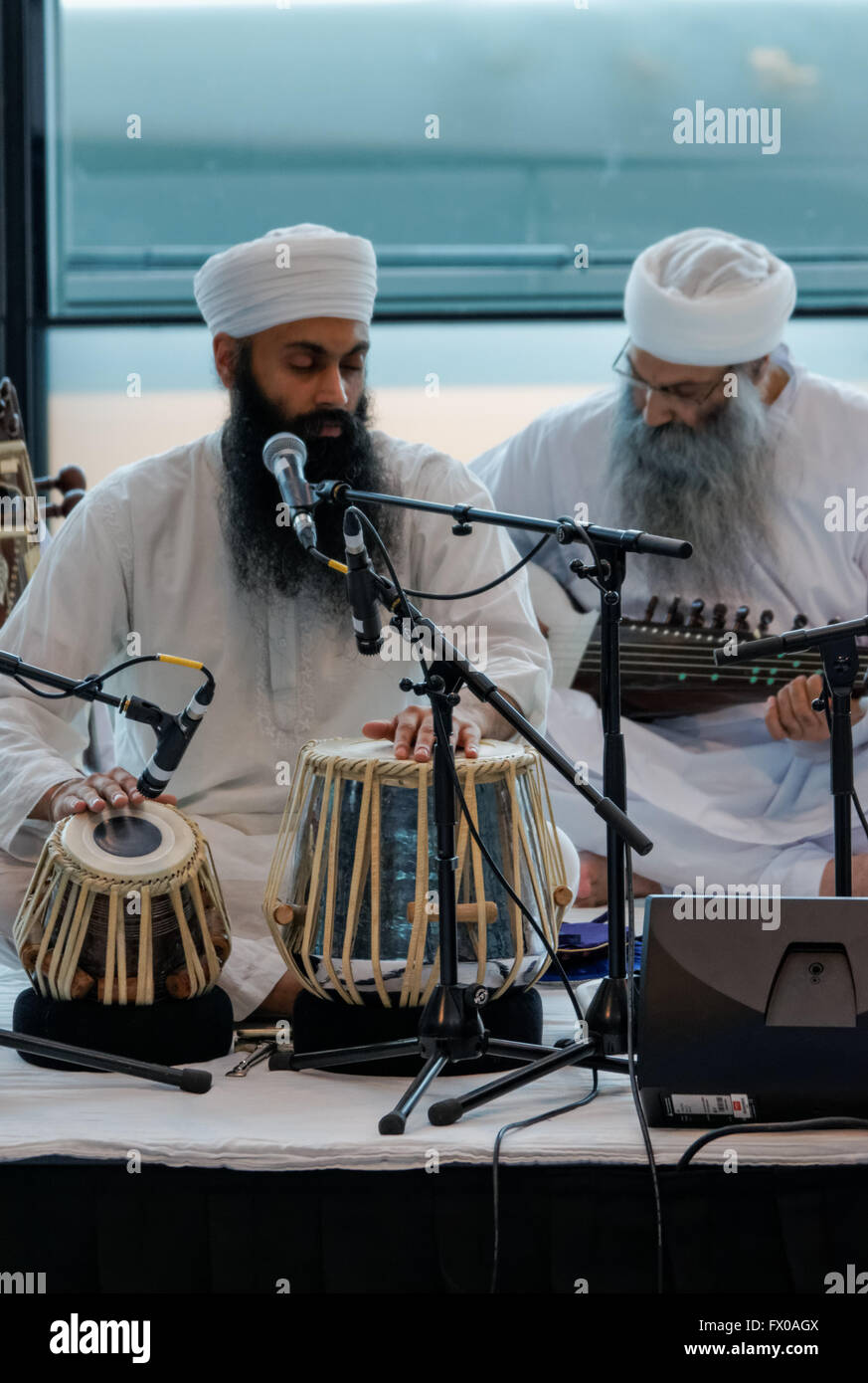 Man playing tabla drums at the Vaisakhi (the Sikh New Year) Festival celebrations at City Hall in London, England United Kingdom UK Stock Photo