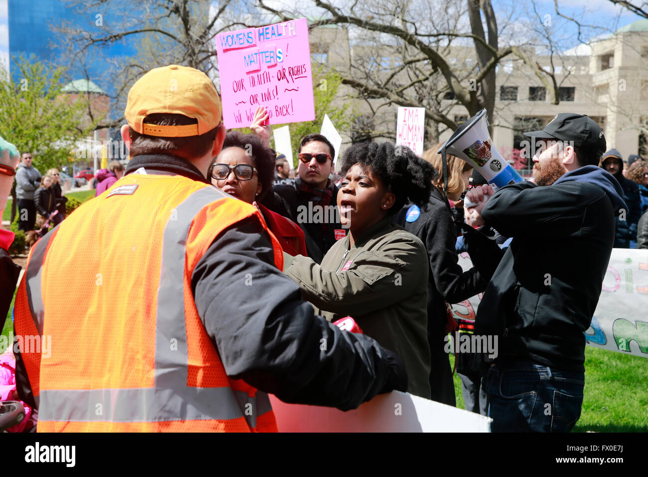 Indianapolis, Indiana, USA. 9th Apr, 2016. About 2000 protesters participate in the Rally for Women's Rights on the south lawn of the Indiana Statehouse, April 9, 2016 in Indianapolis, Ind.  The protest was a response to Indiana's newly passed abortion law House Bill 1337 signed into law by Indiana Governor Mike Pence on March 24, 2016. The Indiana law prohibits abortion if the fetus may be born with a disability, and also restricts a woman from terminating her pregnancy solely because of the gender or race of the fetus. Two black lives matter women argue with a counter protester. Stock Photo