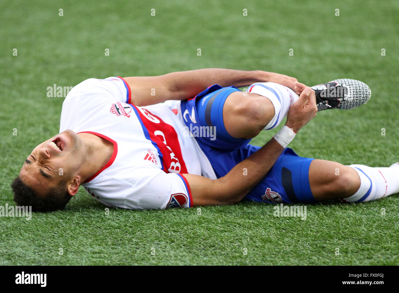 April 9, 2016; Foxborough, MA, USA; Toronto FC defender Justin Morrow (2) grimaces while grabbing his ankle during the second half of an MLS game between the New England Revolution and Toronto FC at Gillette Stadium. The gamed ended in a 1-1 draw. © Cal Sport Media/Alamy Live News Stock Photo