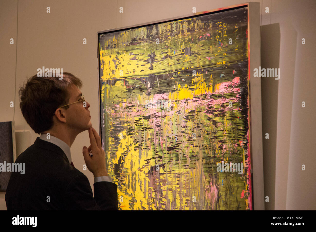 London, UK. 8 April 2016. A Sotheby's employee looks at the painting Abstraktes Bild, 1988, by Gerhard Richter. Estimate USC 3.5-4.5 million. Sotheby's London Auction Preview of art from the Contemporary Art Evening Auction in New York on 11 May 2016. Stock Photo