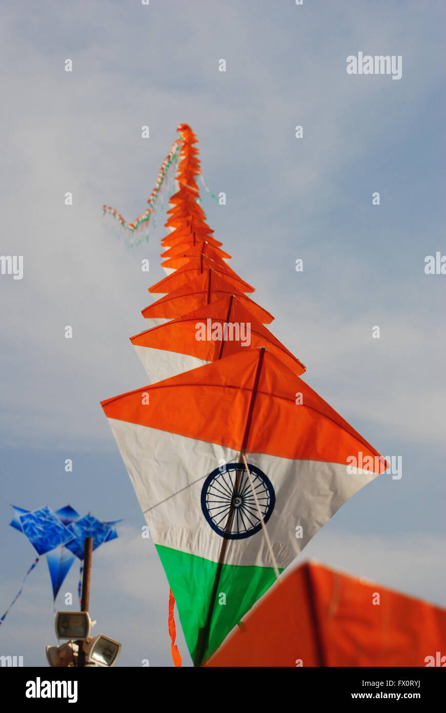 a bright and colourful Indian flag shaped kite flying during the Kite