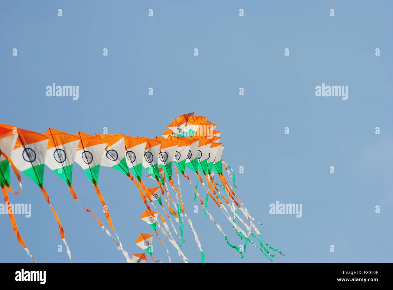 a bright and colourful Indian flag shaped kite flying during the Kite