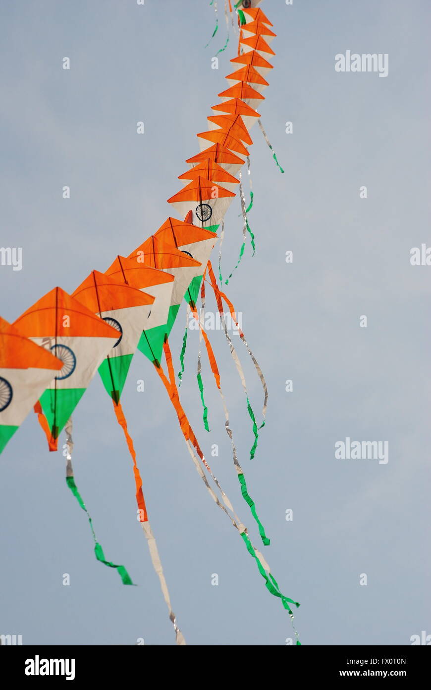 a bright and colourful Indian flag shaped kite flying during the Kite