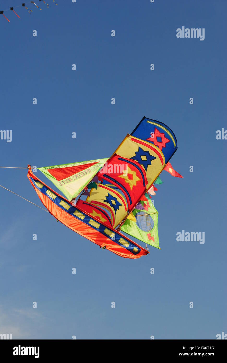 a bright and colourful ship shaped kite flying during the Kite Flying
