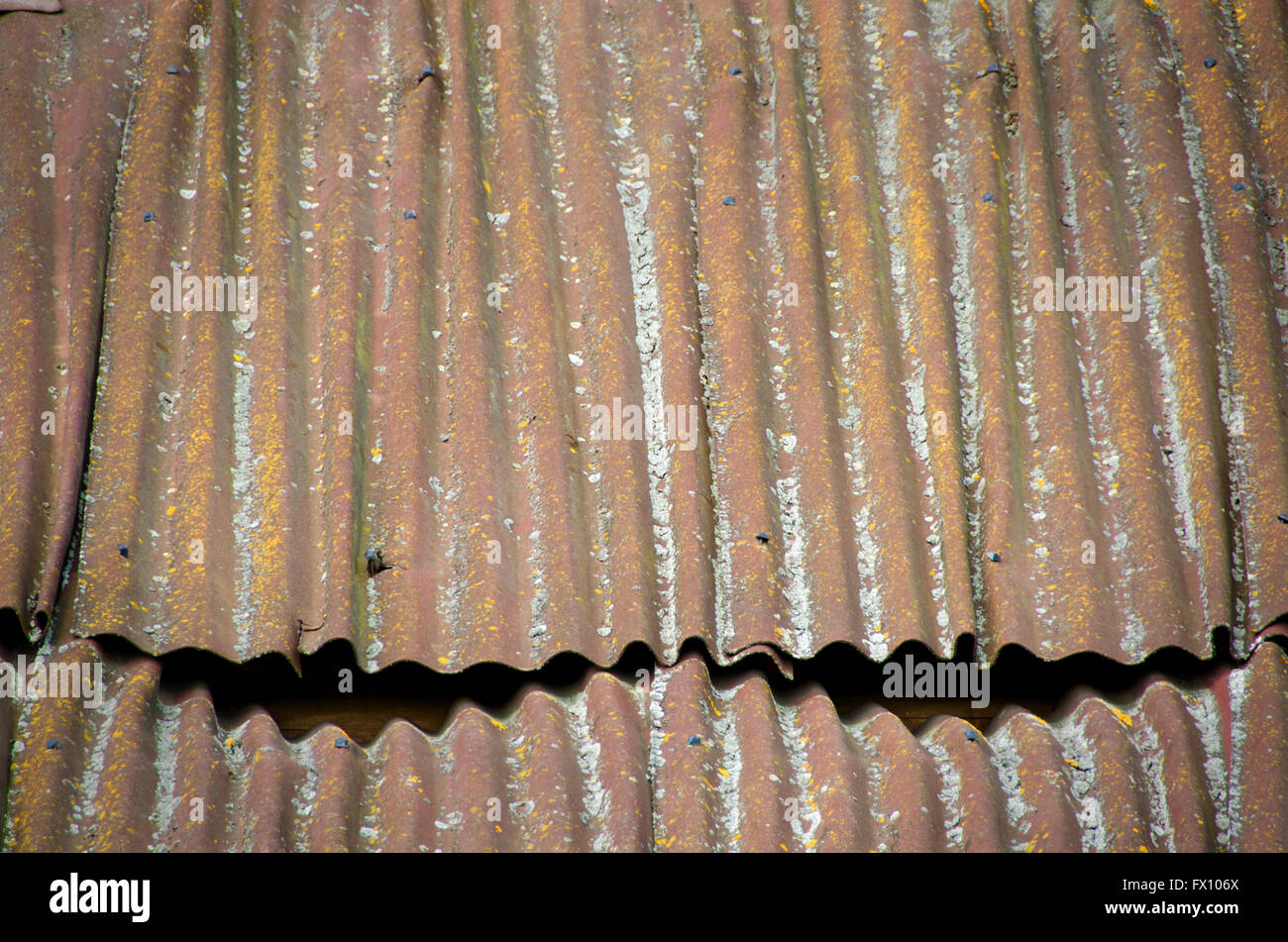 Old roof made of corrugated metal plate. Stock Photo