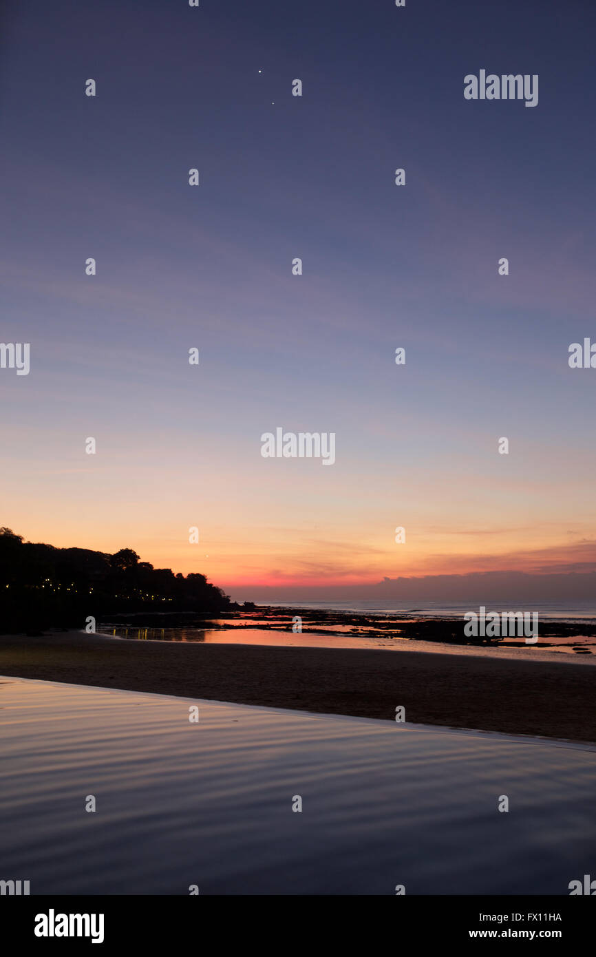 Bali sunset over infinite pool Stock Photo