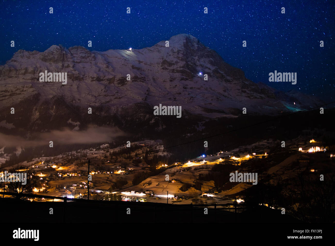 View of Eiger north face, Alps, Switzerland on clear starry night. Eiger Nordwand mountain in Swiss Bernese Alps Stock Photo