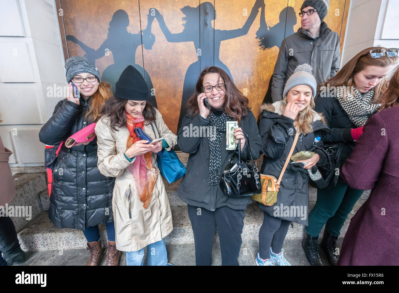 Winners line up with their cash at the Richard Rodgers Theatre in Times Square in New York on Wednesday, April 6, 2016 after their names are called for tickets in the #Ham4Ham lottery for seats for the Broadway blockbuster 'Hamilton'. The $10 live lottery takes place in front of the theater for the Wednesday matinee performance while for the rest of the week's performances the lottery is online. (© Richard B. Levine) Stock Photo