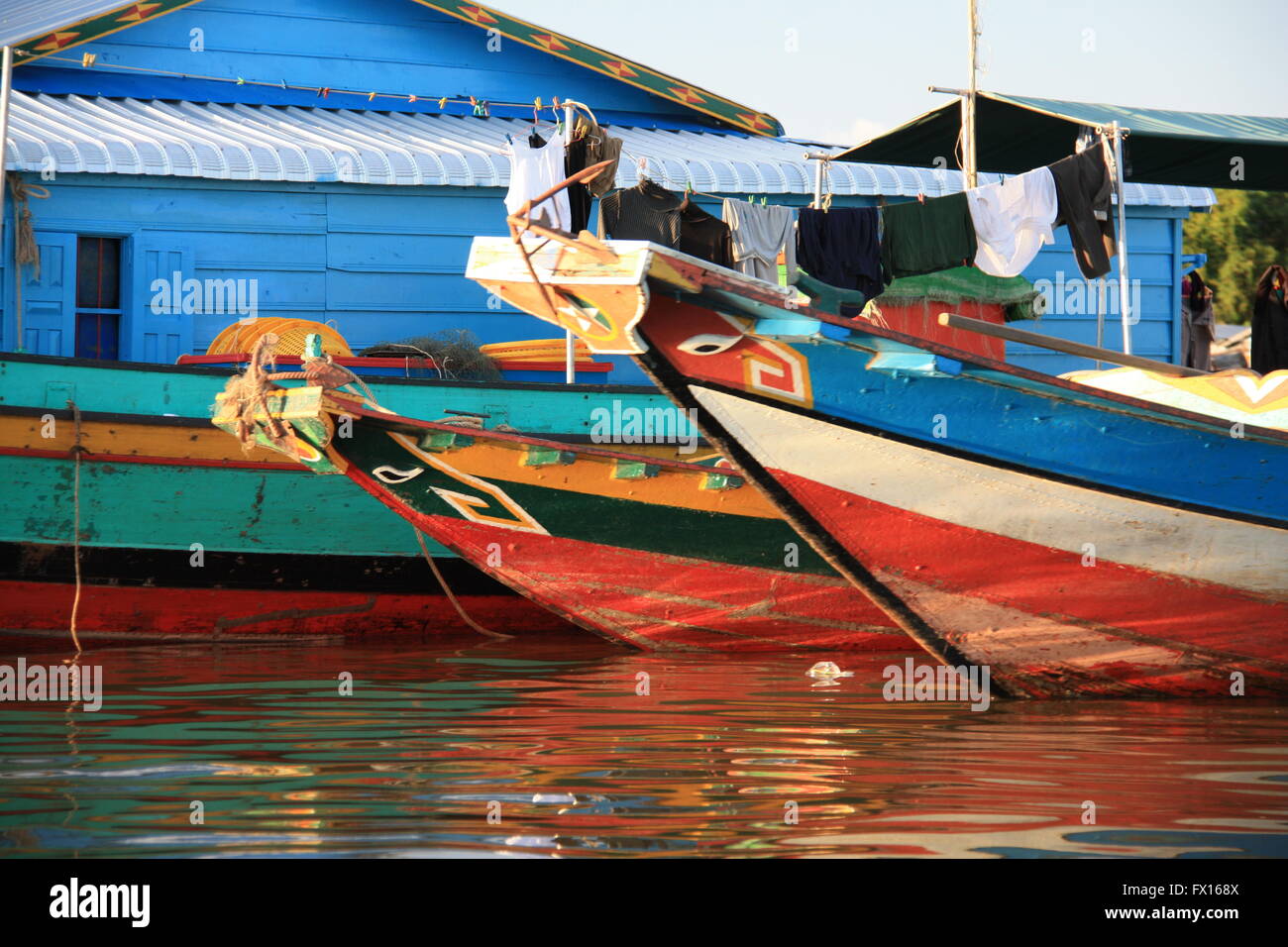 Painted boats amongst the floating villages on Tonle Sap lake, Cambodia Stock Photo