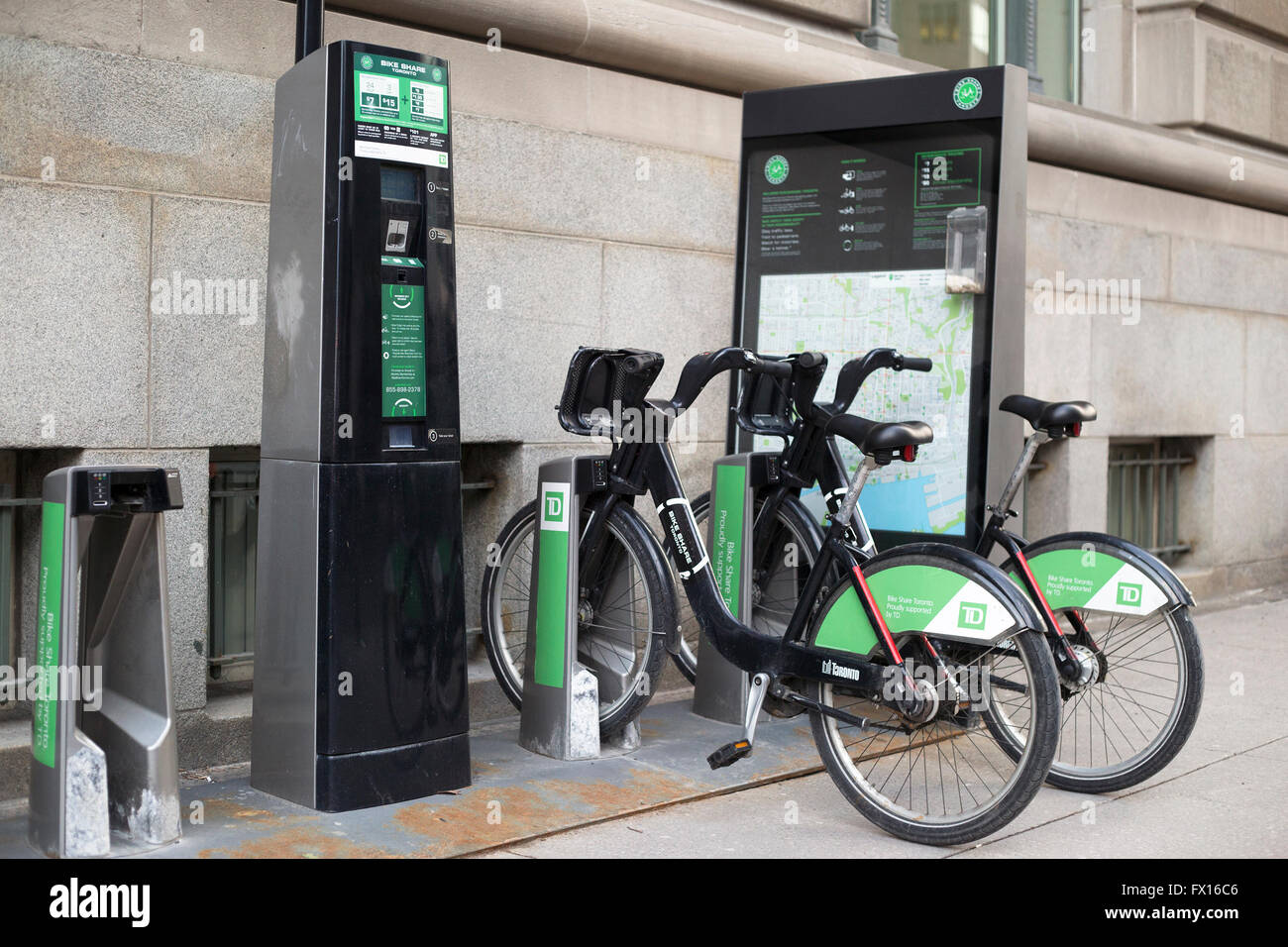 Bicycle share rental station outside office building in downtown