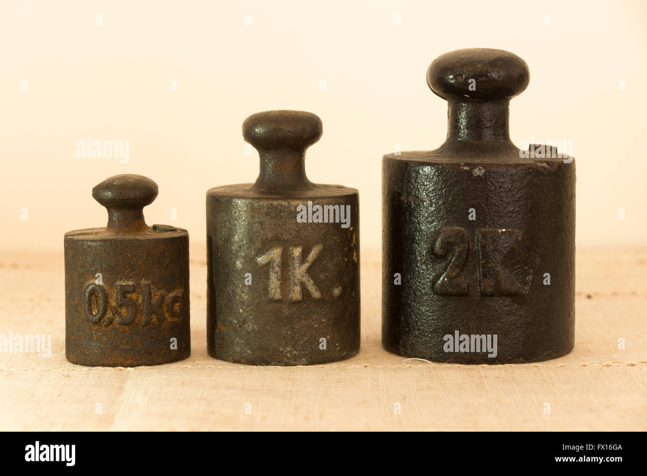 A series of antique weights for use with a weighing scale Stock Photo
