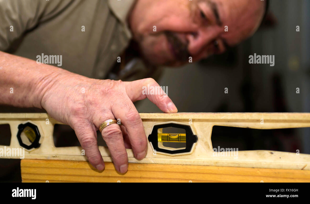 Carpenter using a level Stock Photo Alamy