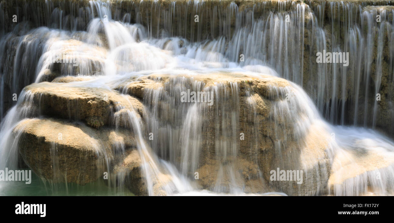 Green rushing water flowing over rocks Stock Photo - Alamy