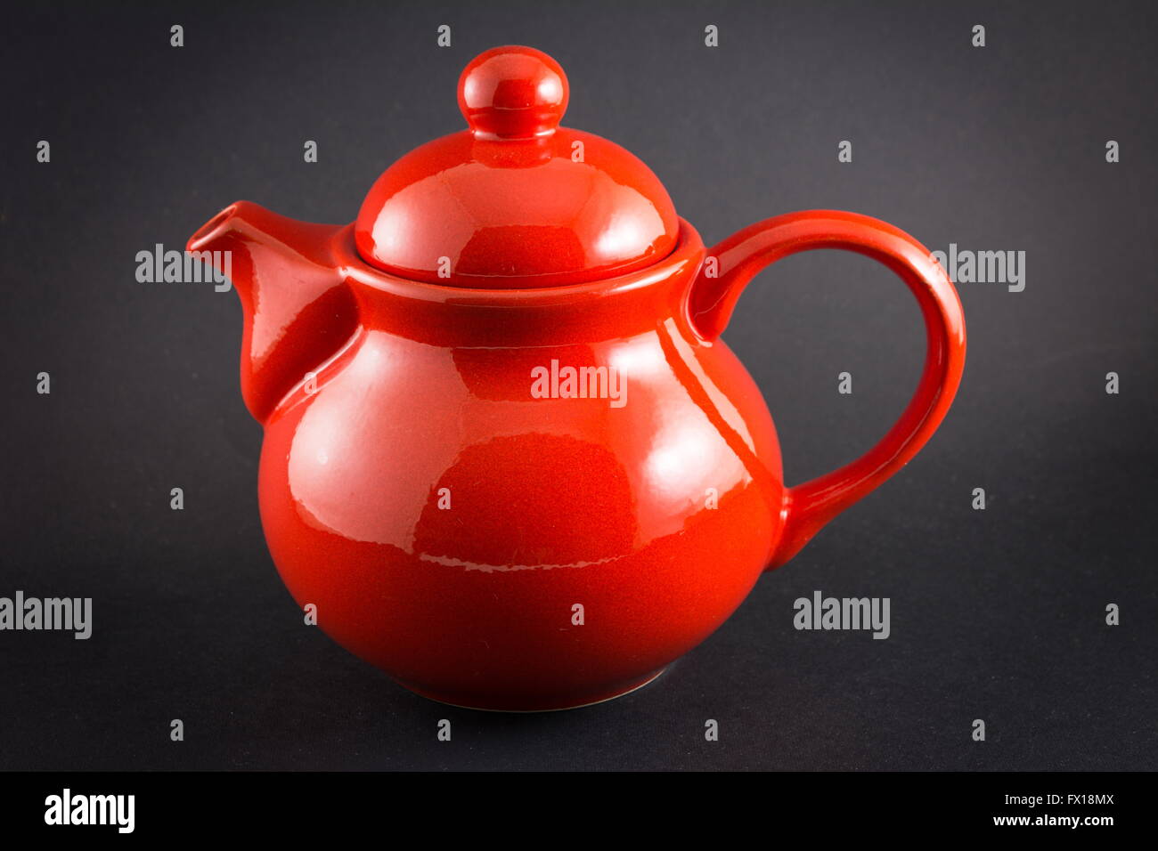 Read shiny teapot on black background Stock Photo