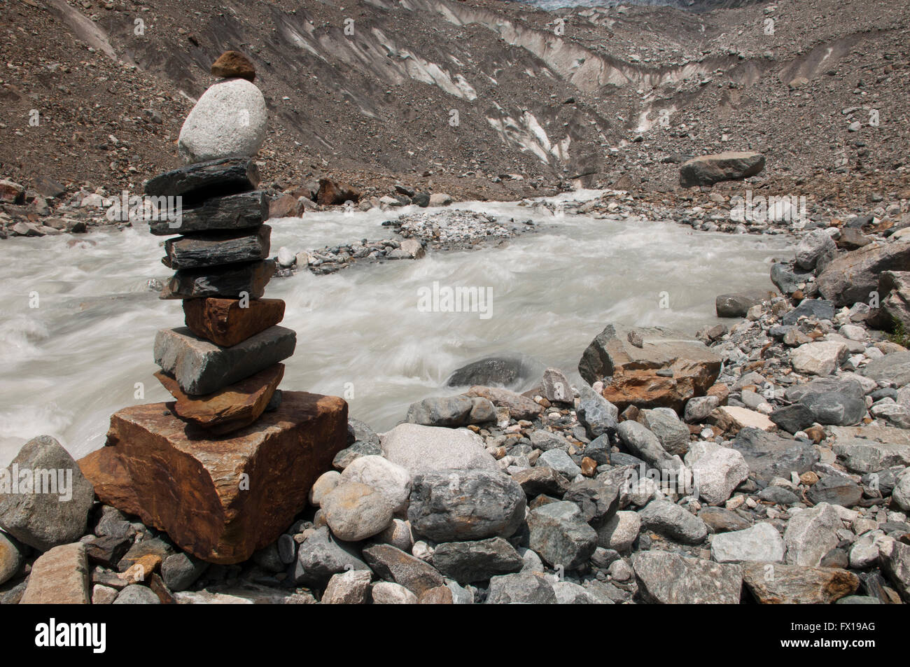 Stacks of rocks  called cairns, ducks or duckies along a river from melting Chalaadi glacier, Mestia, Georgia Stock Photo