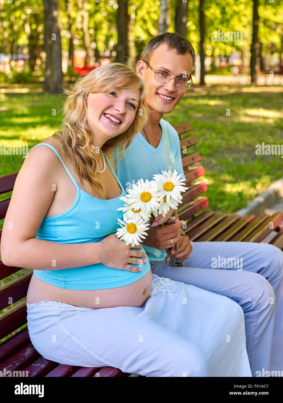 Pregnant woman with a man in the park Stock Photo - Alamy