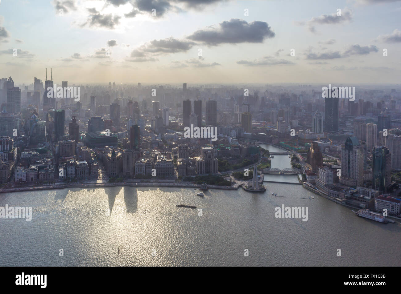 Shanghai city scape with boats in river. Picture was taken in 2014 close to sunset. Stock Photo