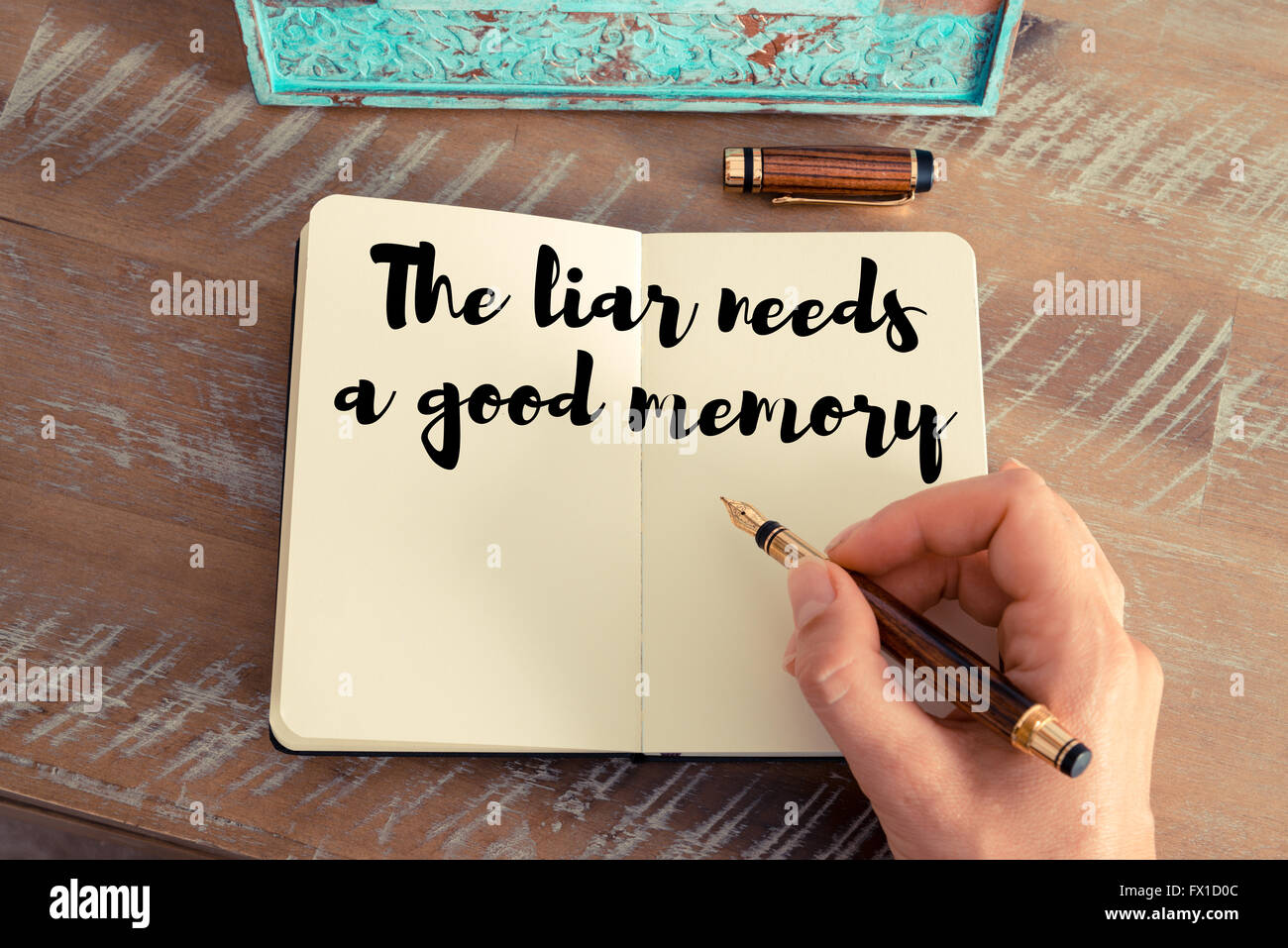 Retro effect and toned image of a woman hand writing on a notebook ...
