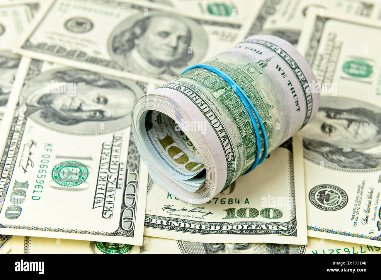 Big roll of dollars bills over banknotes Stock Photo Alamy