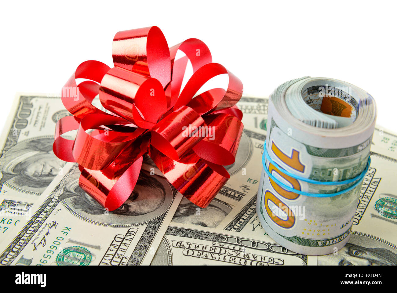Roll stack of cash with red bow on banknotes  isolated. Money gift Stock Photo