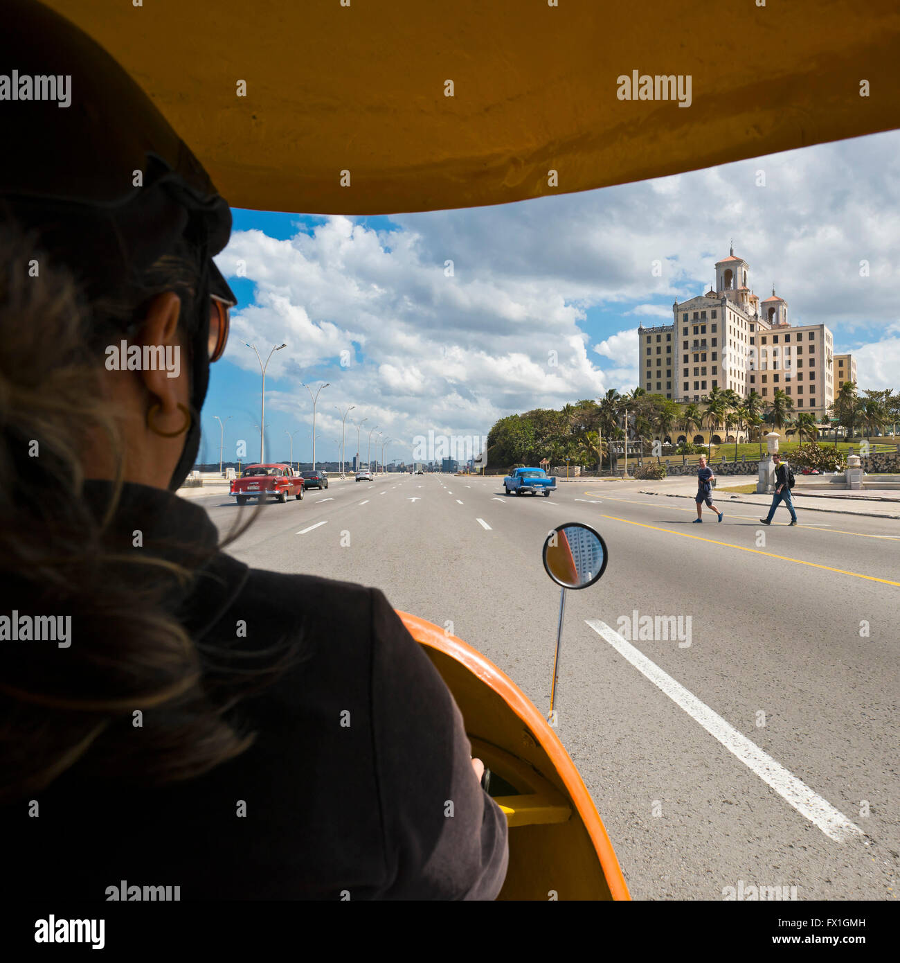 Square view of the Hotel National in Havana from a bright yellow coco taxi, Cuba. Stock Photo
