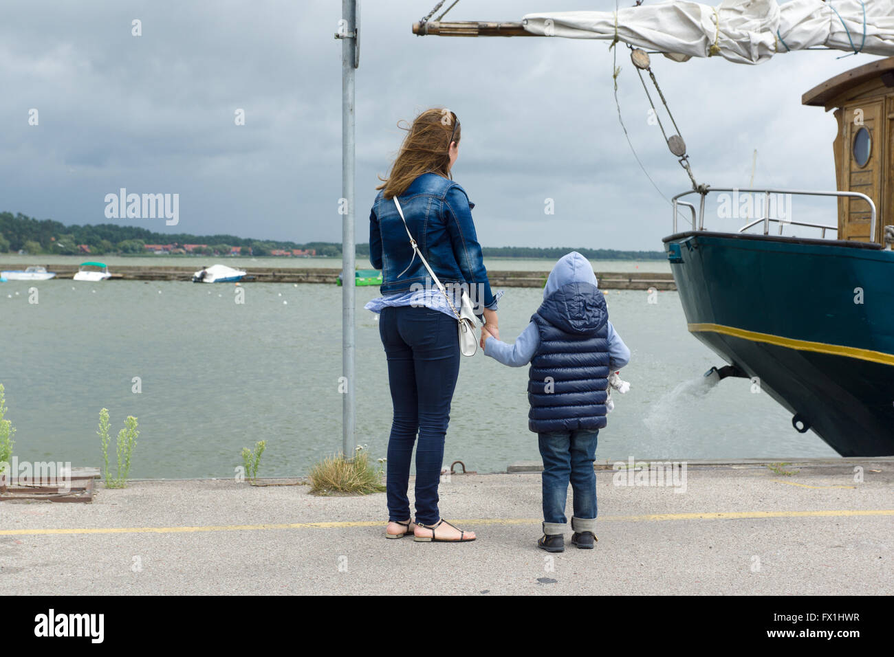mother with the son stand near the sea with which the cold wind blows Stock Photo