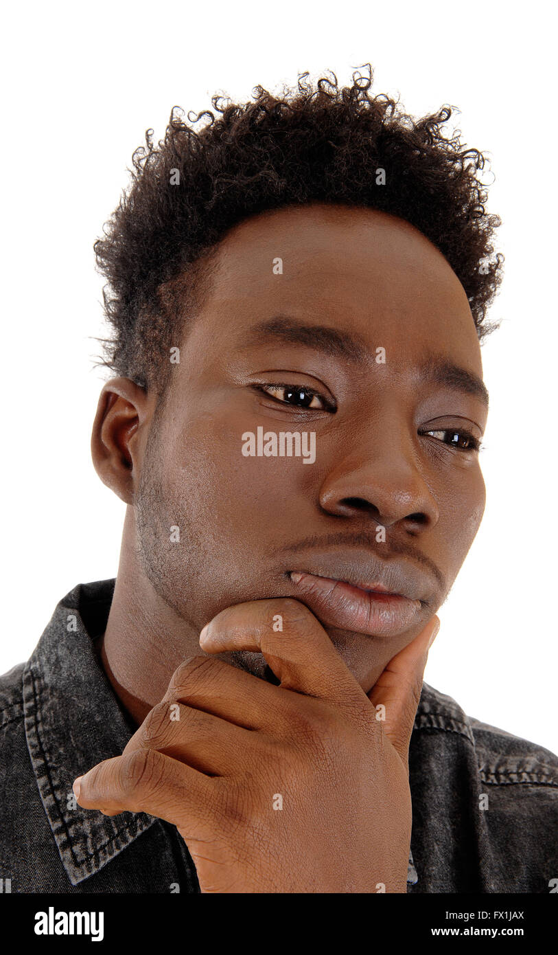 A head shot of the face of a young African American man with his hand ...