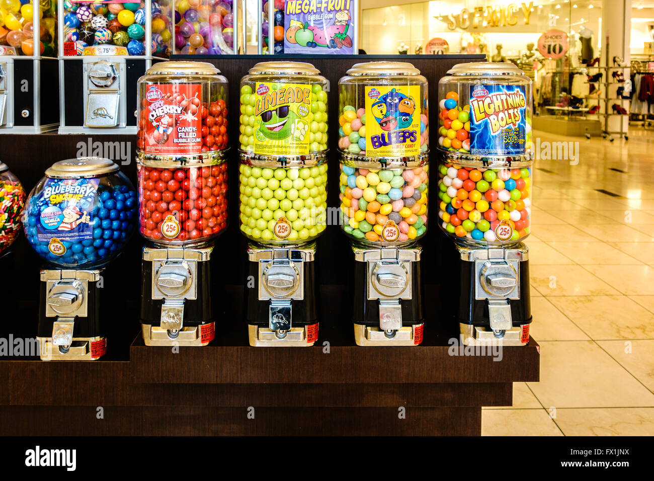 Round candies and bubblegum in coin operated dispensers in a shopping mall. Oklahoma, USA. Stock Photo