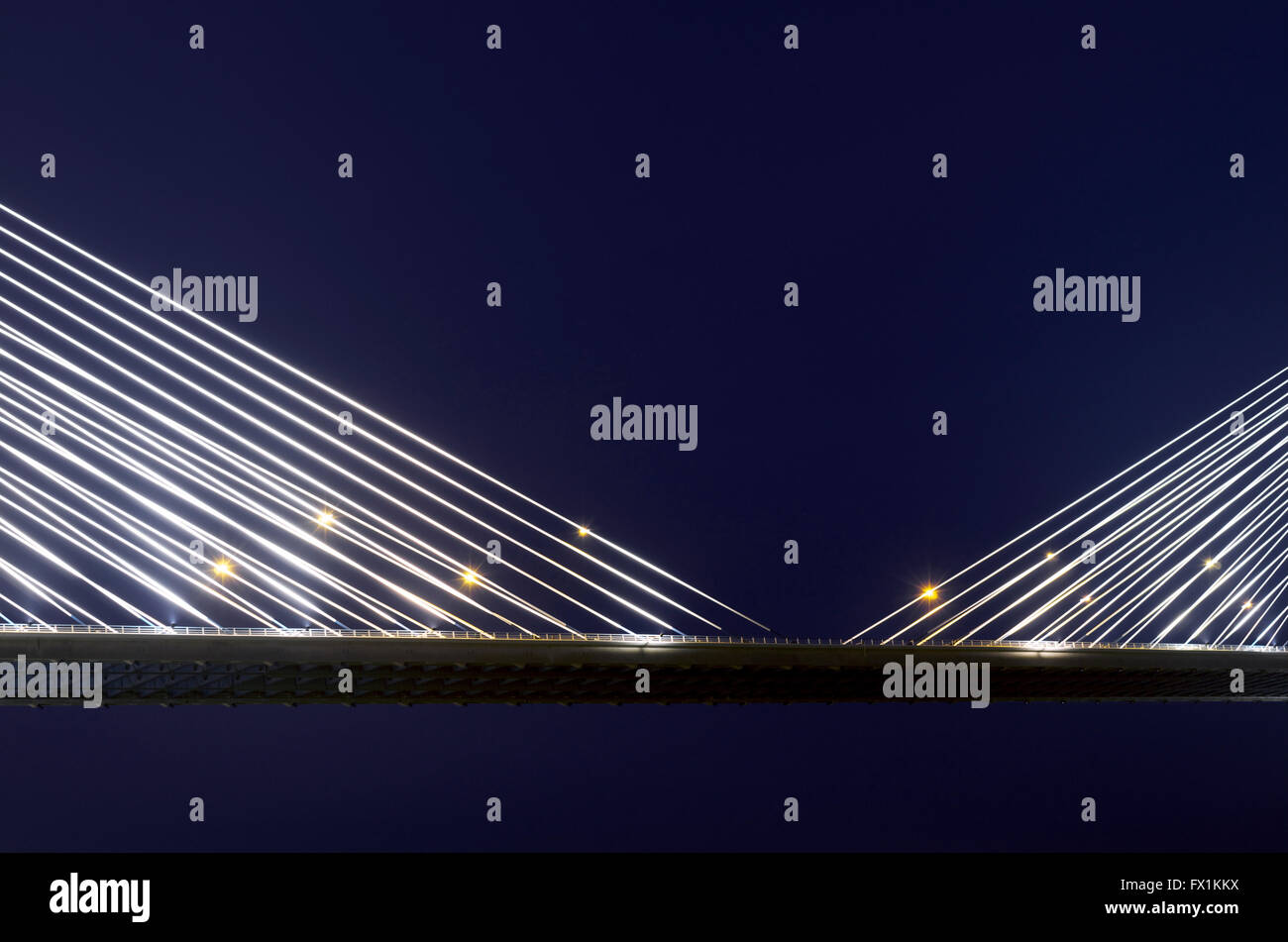 Suspension cables on the Vasco da Gama bridge, illuminated at night. Portugal Stock Photo