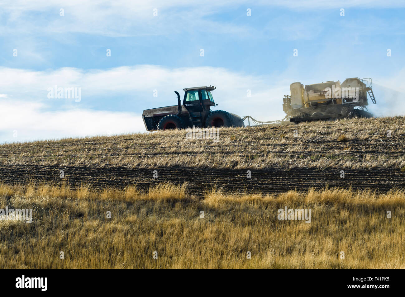 Tractor pulling a planter and sprayer on a farm in eastern Washington.  Saint John, Washington Stock Photo