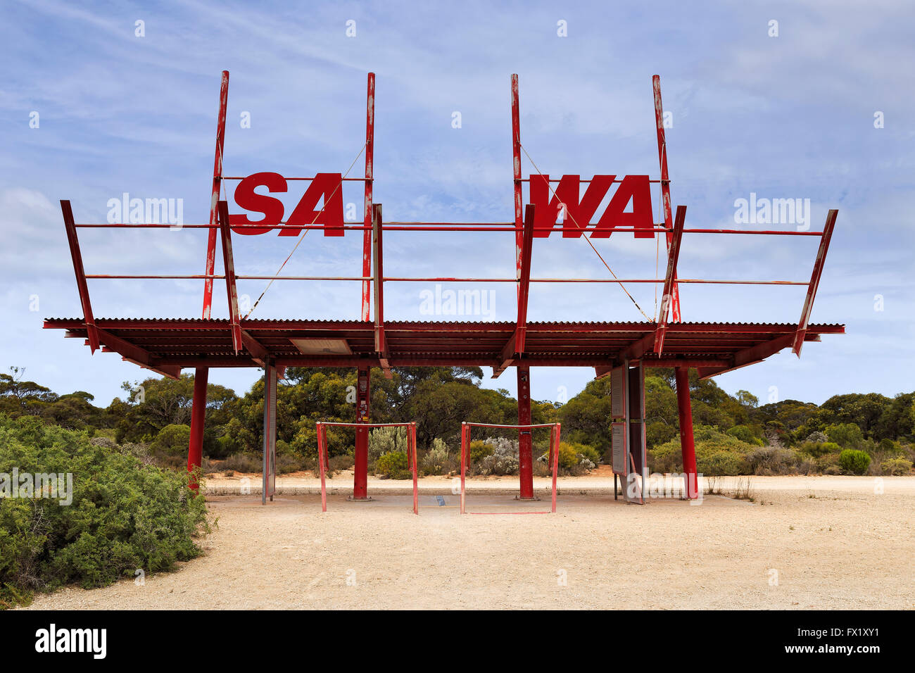 SA WA border village and border sign in a shape of old metal gate pavilion against blue sky in remote outback. Stock Photo