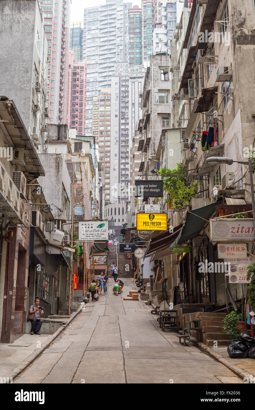 Narrow street and high-rise buildings at the Mid-Levels in Central, Hong Kong, China. Stock Photo